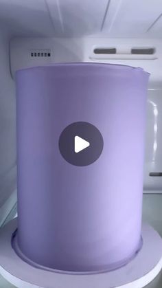 a purple trash can sitting on top of a white counter