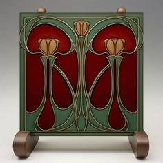 an art deco style cabinet with two flowers on it