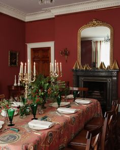 a dining room table is set with plates and place settings