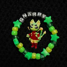 a green and yellow bracelet with an image of a cartoon character on it