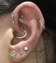 a woman with three different piercings on her ear