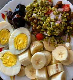 a white plate topped with sliced up bananas and other foods