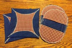 two pieces of blue and red fabric sitting on top of a wooden table next to each other