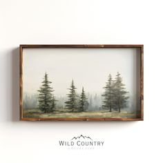 a painting hanging on the wall above a wooden frame with trees in front of it