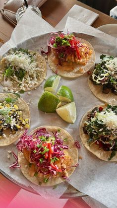 six tacos with various toppings on a plate