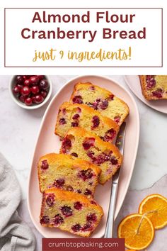 cranberry bread on a plate with oranges and cherries in the background