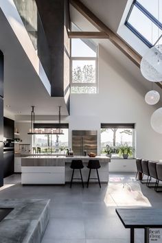 an open living room and dining area with skylights