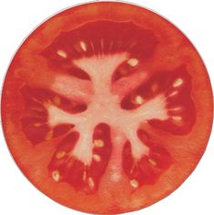 a tomato cut in half sitting on top of a white plate