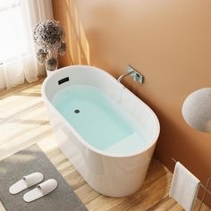 a bath tub sitting on top of a wooden floor