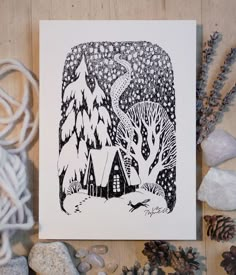 a black and white drawing of a cabin in the woods surrounded by rocks, pine cones and snow