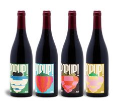 three bottles of wine with different designs on them