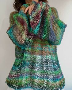 a woman wearing a multicolored knitted sweater