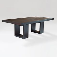 the table is made out of wood and has two square bases on each side, with one end missing