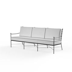 a white couch sitting on top of a metal frame