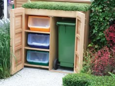 an outdoor storage area with bins and trash cans