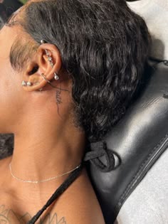 a woman with ear piercings sitting in a chair