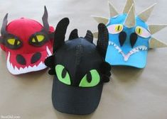 three different types of stuffed animals with green eyes and black ears, one is wearing a dragon hat