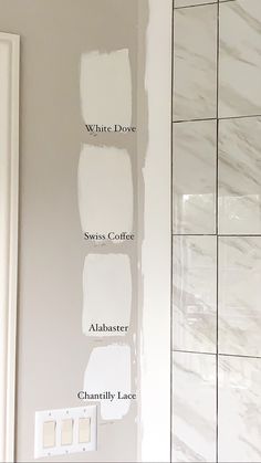 the walls in this bathroom are all white and have different shades of paint on them