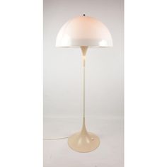 an image of a lamp that is on the floor in front of a white background