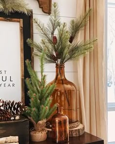 there is a vase with pine cones in it on the table next to other decorations