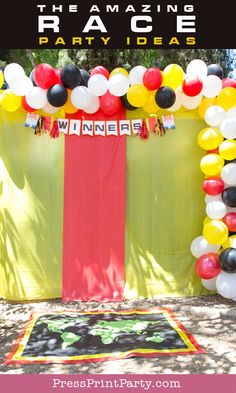 an arch made out of balloons and streamers for a race party