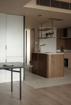 an empty kitchen and dining room with wood flooring