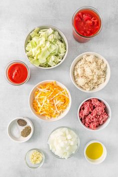 the ingredients to make an appetizer laid out in bowls on a white surface