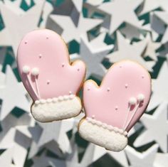 two pink and white heart shaped cookies on top of each other with stars in the background