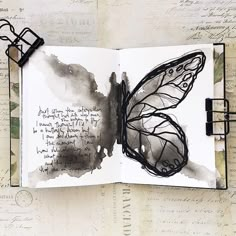 an open book with a butterfly drawn on it