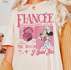 a woman wearing a t - shirt with an image of minnie mouse on it