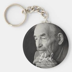 a black and white photo of an old man with the words dad on it keychain