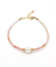 A lustrous freshwater pearl and an ombre fade of pink opal are layered together to create this fresh seaside style. Crafted to last for years to come from natural gemstones and high quality 14k gold fill that is hypoallergenic and waterproof. *Pairs with our Adria Pearl Ombre Necklace >> https://www.etsy.com/listing/1525106461 Materials: Freshwater pearl | Pink Opal | 14k gold filled beads, clasp and extender Measurements: 7 - 8" Adjustable Length | 10 mm pearl, 3.5 mm gemstones Handcrafted in F