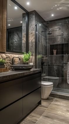 a bathroom with a sink, toilet and shower stall in the middle of the room