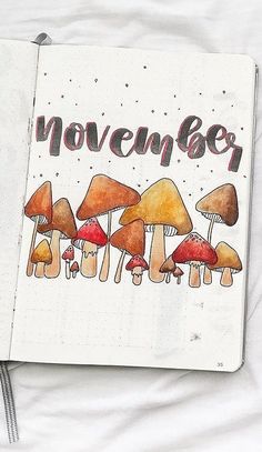 an open notebook with mushrooms and the words november written in red ink on white paper