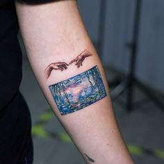 two hands touching each other over a painting on the left arm and wrist tattoo design