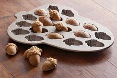 a muffin tray filled with cookies on top of a wooden table