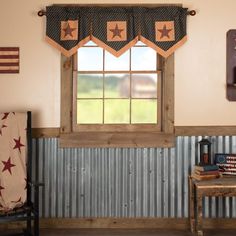 a room with a chair, window and american flag banner on the wall above it