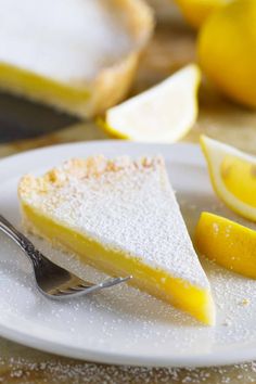 a slice of lemon pie on a plate with a fork