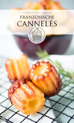 some food is sitting on top of a wire rack with the words franzosice canneles