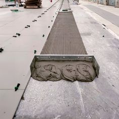 a concrete walkway with three heads on it