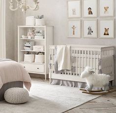 a baby's room with white furniture and pictures on the wall, including a crib