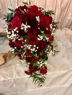 a bouquet of red roses and baby's breath