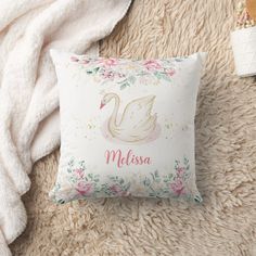 a white pillow with a pink swan on it and the word miss written in gold