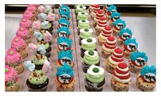 there are many cupcakes with different designs on them, all decorated in different colors