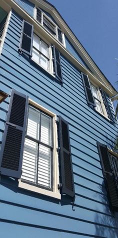 an apartment building with shutters on the windows