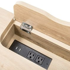 an electrical outlet in the side of a wooden box with two outlets on each side