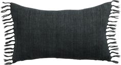 a black pillow with fringes on it