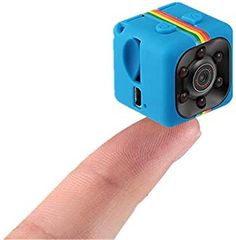 a small blue camera sitting on top of a finger