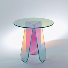 a colorful glass table with curved legs