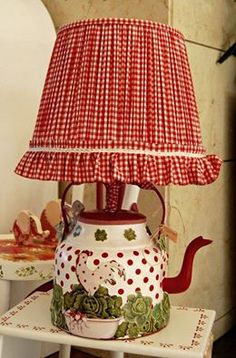 a red and white lamp sitting on top of a table